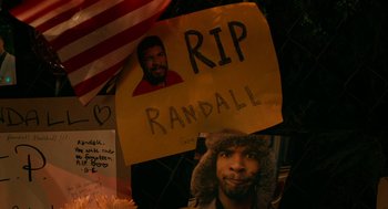 Movie still from “Blindspotting” (2018), directed by Carlos López Estrada – A sign with a picture of a man; Extreme Close Up shot, Overhead angle