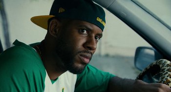 Movie still from “Blindspotting” (2018), directed by Carlos López Estrada – A person wearing a hat; Close Up shot, Low angle