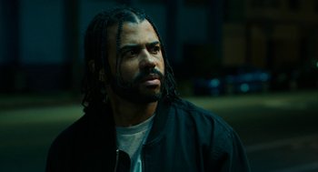 Movie still from “Blindspotting” (2018), directed by Carlos López Estrada – A person wearing a jacket with long dreadlocks; Close Up shot, Low angle