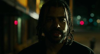Movie still from “Blindspotting” (2018), directed by Carlos López Estrada – A person with dreadlocks; Close Up shot, Low angle