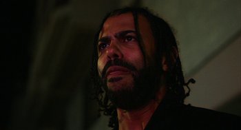 Movie still from “Blindspotting” (2018), directed by Carlos López Estrada – A person with long hair; Close Up shot, Low angle
