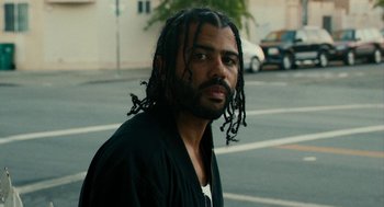 Movie still from “Blindspotting” (2018), directed by Carlos López Estrada – A person with dreadlocks on the street; Close Up shot, Low angle