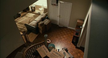 Movie still from “Blindspotting” (2018), directed by Carlos López Estrada – A view of a living room from the top of a spiral stair case; Extreme Wide shot, High angle
