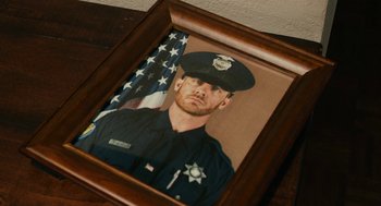 Movie still from “Blindspotting” (2018), directed by Carlos López Estrada – A picture of a police officer in a frame; Extreme Close Up shot, High angle