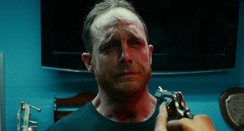 Movie still from “Blindspotting” (2018), directed by Carlos López Estrada – A person holding a gun; Close Up shot, Over the shoulder angle