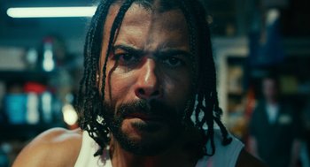 Movie still from “Blindspotting” (2018), directed by Carlos López Estrada – A person with dreadlocks; Close Up shot, Low angle