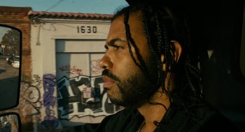 Movie still from “Blindspotting” (2018), directed by Carlos López Estrada – A person with dreadlocks; Close Up shot, Low angle