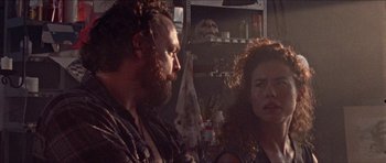 Movie still from “Bliss” (2019), directed by Joe Begos – A man and a woman are looking at each other; Close Up shot, Over the shoulder angle