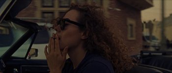 Movie still from “Bliss” (2019), directed by Joe Begos – A person eating food; Close Up shot, High angle