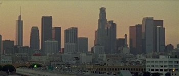 Movie still from “Bliss” (2019), directed by Joe Begos – A view of a city skyline at sunset; Extreme Wide shot, High angle