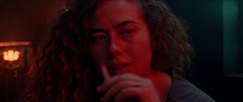 Movie still from “Bliss” (2019), directed by Joe Begos – A person smoking a cigarette; Close Up shot, Low angle