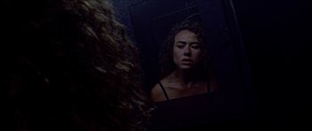 Movie still from “Bliss” (2019), directed by Joe Begos – A woman looking at herself in the mirror; Close Up shot, Overhead angle
