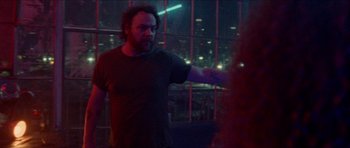 Movie still from “Bliss” (2019), directed by Joe Begos – A man is holding his hand out to another man; Medium shot, Over the shoulder angle