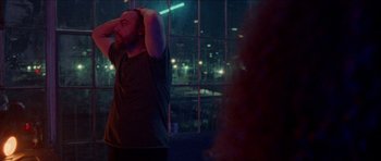 Movie still from “Bliss” (2019), directed by Joe Begos – A man standing in front of a window at night; Medium shot, Over the shoulder angle