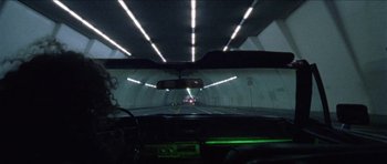 Movie still from “Bliss” (2019), directed by Joe Begos – A view from inside a car looking at a tunnel; Extreme Wide shot, High angle