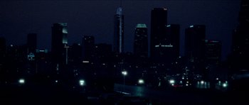 Movie still from “Bliss” (2019), directed by Joe Begos – A view of a city at night with lights on; Extreme Wide shot, High angle