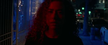 Movie still from “Bliss” (2019), directed by Joe Begos – A person with curly hair; Close Up shot, Low angle