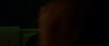 Movie still from “Bliss” (2019), directed by Joe Begos – A blurry image of a person standing in the dark at night; Close Up shot, Over the shoulder angle