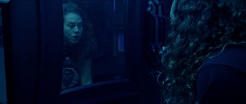 Movie still from “Bliss” (2019), directed by Joe Begos – A woman looking in the mirror in front of a mirror; Close Up shot, Over the shoulder angle