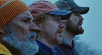 A group of three men with beards and hats