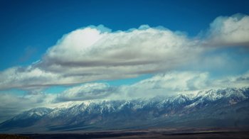 Movie still from “Blue Jay” (2016), directed by Alex Lehmann – A large mountain range under a cloudy sky; Extreme Wide shot, Low angle
