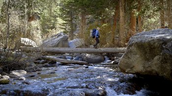 Movie still from “Blue Jay” (2016), directed by Alex Lehmann – A man walking across a bridge over a river; Wide shot, High angle