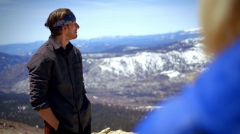 Movie still from “Blue Jay” (2016), directed by Alex Lehmann – A man standing on top of a mountain looking at the sky; Medium shot, Low angle