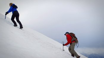 Movie still from “Blue Jay” (2016), directed by Alex Lehmann – A man in a red jacket climbing up a snow covered hill; Extreme Wide shot, Low angle