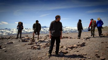 Movie still from “Blue Jay” (2016), directed by Alex Lehmann – A group of men standing on top of a rocky hill; Wide shot, Low angle