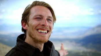 Movie still from “Blue Jay” (2016), directed by Alex Lehmann – A person with a smile on his face; Close Up shot, Low angle