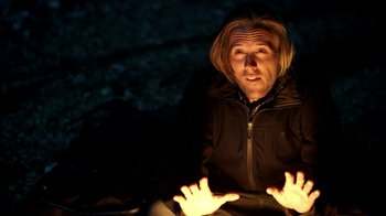 Movie still from “Blue Jay” (2016), directed by Alex Lehmann – A man sitting on the ground in the dark; Close Up shot, High angle