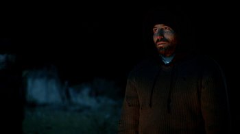 Movie still from “Blue Jay” (2016), directed by Alex Lehmann – A man wearing a hooded jacket standing in the dark; Medium shot, Low angle