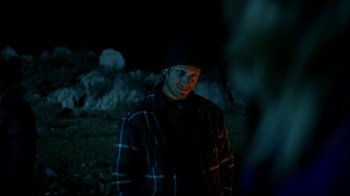 Movie still from “Blue Jay” (2016), directed by Alex Lehmann – A man standing in a field at night; Medium shot, Over the shoulder angle
