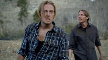 Movie still from “Blue Jay” (2016), directed by Alex Lehmann – A man with long blonde hair is standing next to another man; Medium shot, Over the shoulder angle