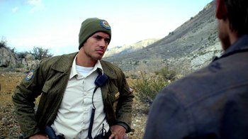 Movie still from “Blue Jay” (2016), directed by Alex Lehmann – A man wearing a hat and jacket on a hill; Medium shot, Over the shoulder angle