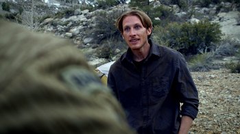 Movie still from “Blue Jay” (2016), directed by Alex Lehmann – A man standing in the middle of a field; Close Up shot, Over the shoulder angle