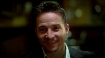 Movie still from “Blue Jay” (2016), directed by Alex Lehmann – A person wearing a suit and smiling; Close Up shot, High angle