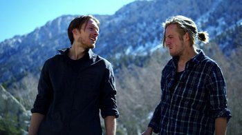 Movie still from “Blue Jay” (2016), directed by Alex Lehmann – Two young men are standing in front of a snowy mountain; Medium shot, Low angle