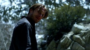 Movie still from “Blue Jay” (2016), directed by Alex Lehmann – A man with long blonde hair standing next to a tree; Close Up shot, Over the shoulder angle