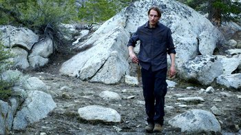 Movie still from “Blue Jay” (2016), directed by Alex Lehmann – A man walking on a trail in the woods; Wide shot, Low angle