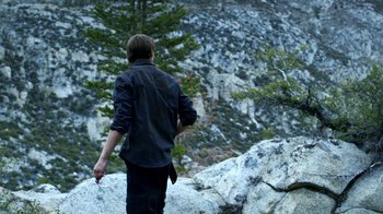 Movie still from “Blue Jay” (2016), directed by Alex Lehmann – A man standing on top of a mountain looking at a tree; Wide shot, Over the shoulder angle