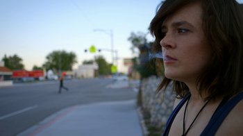 Movie still from “Blue Jay” (2016), directed by Alex Lehmann – A woman is smoking a cigarette on the side of the road; Close Up shot, Low angle