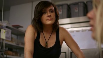 Movie still from “Blue Jay” (2016), directed by Alex Lehmann – A woman in a black tank top is sitting in a kitchen; Close Up shot, High angle