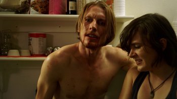 Movie still from “Blue Jay” (2016), directed by Alex Lehmann – A man with a beard is sitting next to a woman in a kitchen; Medium shot, Over the shoulder angle