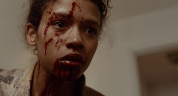 Movie still from “Bones and All” (2022), directed by Luca Guadagnino – A person with blood on their face; Close Up shot, Low angle