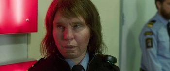 Movie still from “Border” (2018), directed by Ali Abbasi – A woman in a police uniform is looking at the camera; Close Up shot, Over the shoulder angle