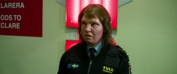 Movie still from “Border” (2018), directed by Ali Abbasi – A person with long hair and a uniform on; Close Up shot, Low angle