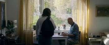 Movie still from “Border” (2018), directed by Ali Abbasi – A man and a woman are sitting at a table; Medium shot, Over the shoulder angle