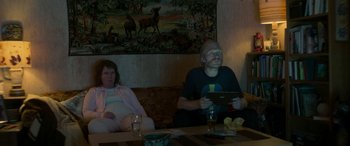 Movie still from “Border” (2018), directed by Ali Abbasi – A man and a woman sitting at a table with an ipad; Medium shot, Over the shoulder angle