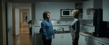 Movie still from “Border” (2018), directed by Ali Abbasi – Two people standing in a kitchen facing each other; Medium shot, Over the shoulder angle